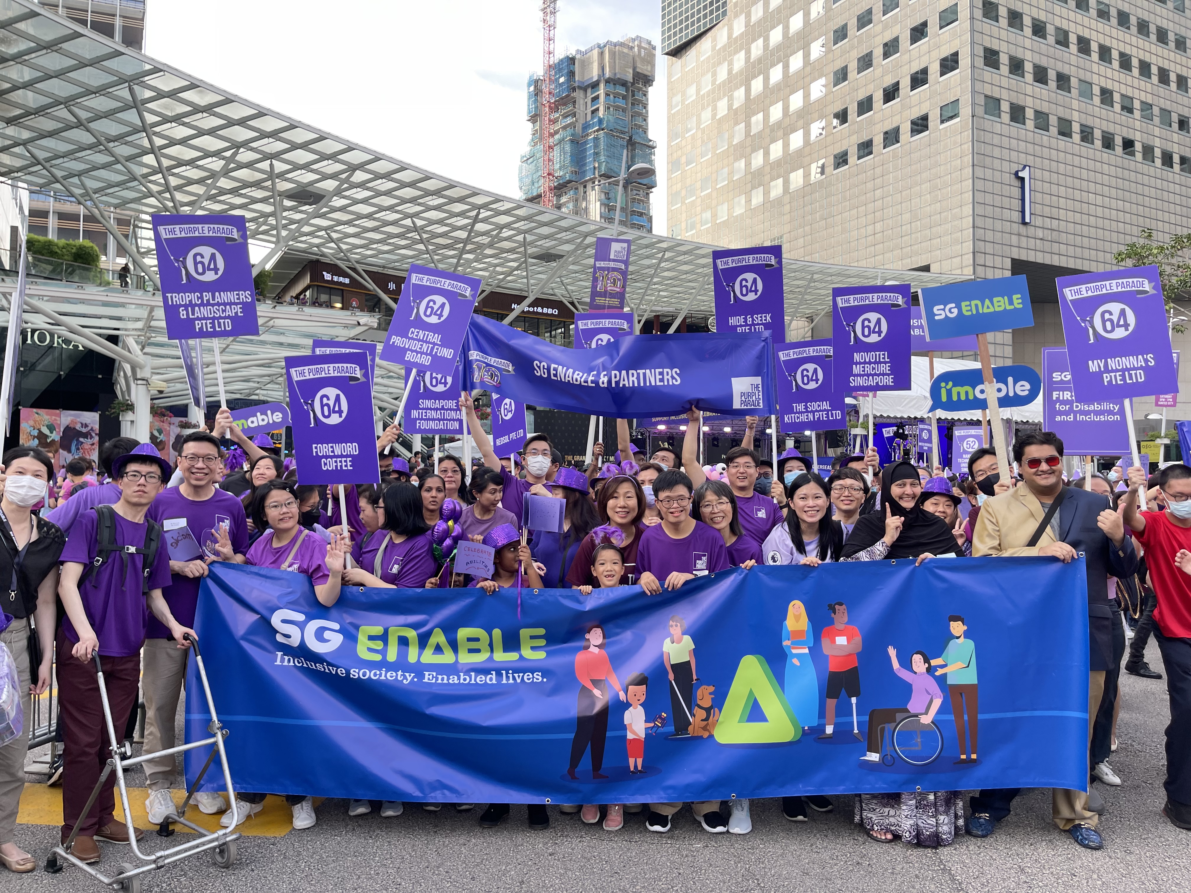 SG Enable staff posing for a group photo at The Purple Parade