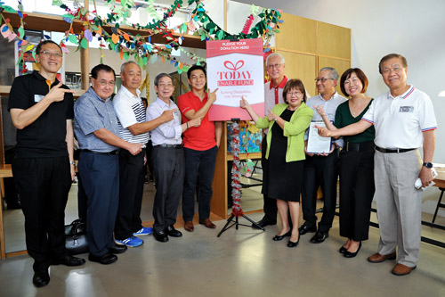 Group photo taken during the launch of TODAY Enable Fund, featuring then Minister of Social and Family Development Mr Tan Chuan Jin, SG Enable's CEO and other invited guests. They are all pointing at a board with Today Enable Fund printed on it.