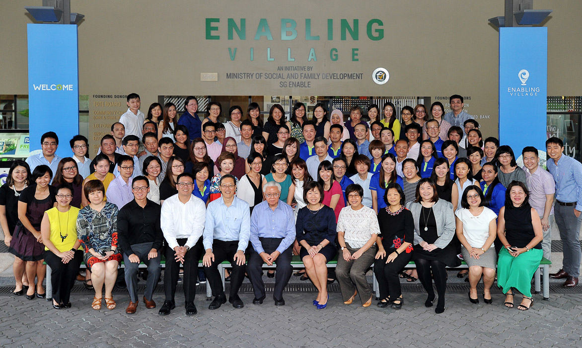 Group photo with President Tony Tan on his visit to Enabling Village. SG Enable staff members pictured are donned in corporate t-shirts.