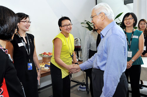 President Tony Tan shakes the hand of a smiling SG Enable staff member during his visit to Enabling Village.