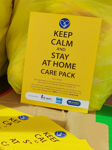 Supporting Persons with Disabilities During the Covid Pandemic - Cover Pamphlet that was distributed together with the care packs at the height of COVID-19. The yellow pamphlet reads "Keep calm and stay at home care pack", with a message below.