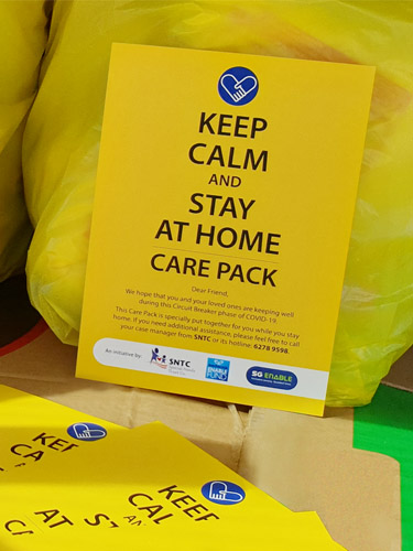 Pamphlet that was distributed together with the care packs at the height of COVID-19. The yellow pamphlet reads "Keep calm and stay at home care pack", with a message below.