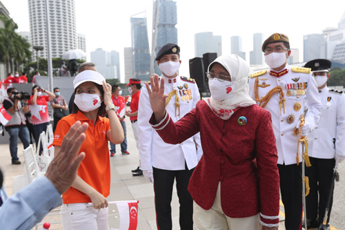 President Halimah Yacob wearing the Indah Cotton-Silk Scarf and Jiwa Enamel Brooch from the Utama Collection at 2020's National Day Parade.