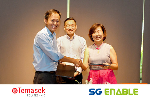 SG Enable's CEO, Ms Ku Geok Boon, shaking hands with Temasek Polytechnic's Principal and CEO, Mr Peter Lam, while Senior Parliamentary Secretary Mr Eric Chua smiles behind them.