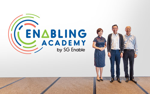 SG Enable's CEO, Ms Ku Geok Boon, and Chairman, Mr Moses Lee, posing with Senior Parliamentary Secretary Mr Eric Chua at the launch of Enabling Academy.