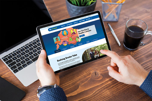 An iPad user scrolls through SG Enable's new corporate website.