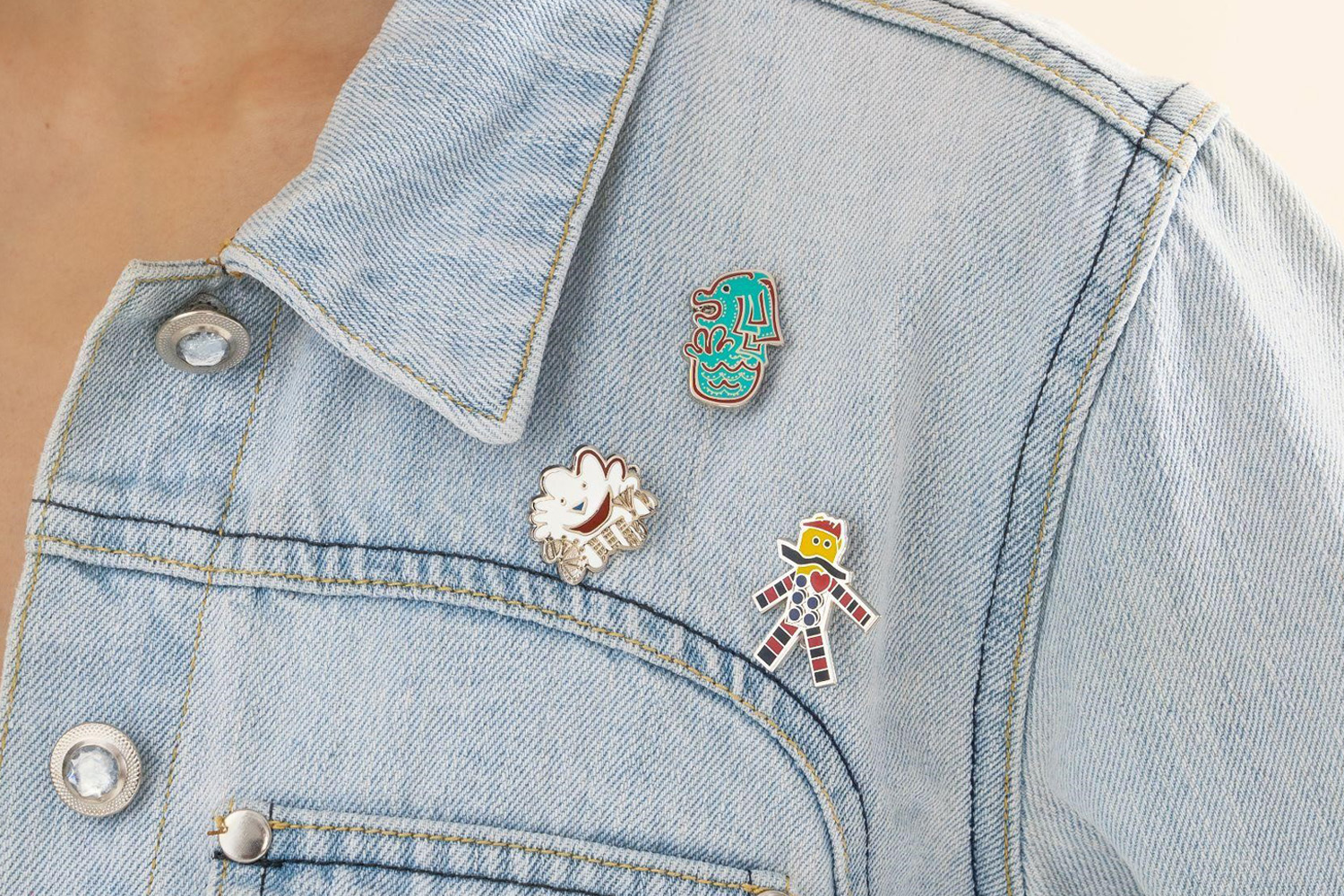 Remix 555 Collection enamel pins attached onto a denim jacket