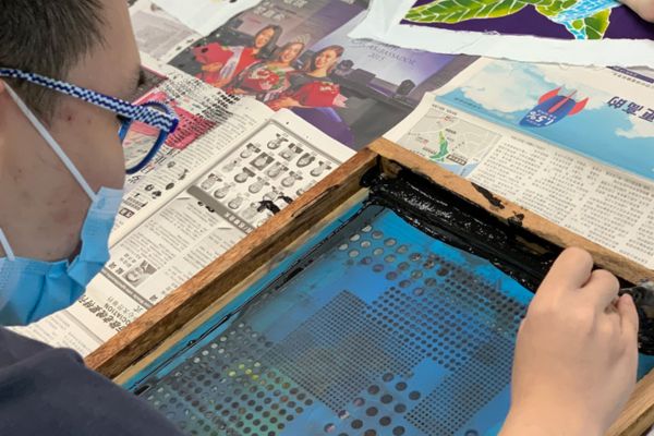 a person holding a silkscreen