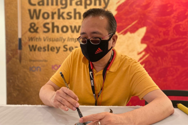 Wesley demonstrating Calligraphy experience at Ion Art
