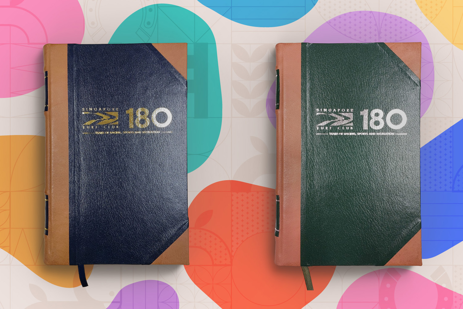 2 customised half-leather bound journals in blue on the left and green on the right.