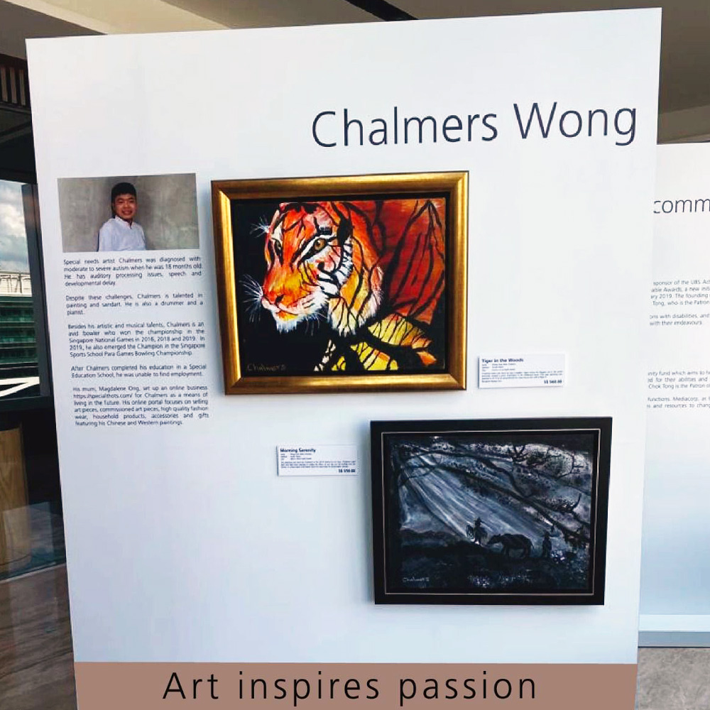 An art exhibit displaying 2 paintings of animals formed by tree branches, accompanied by information of the artist, Chalmers Wong