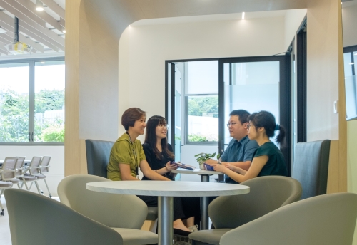 A group of staff and caregivers having a discussion in the Future Care Planning Resource Centre.