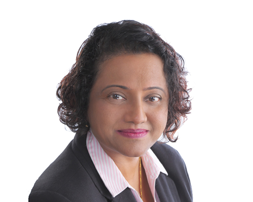 Headshot of a dark-skinned woman with curly hair wearing a corporate blazer.