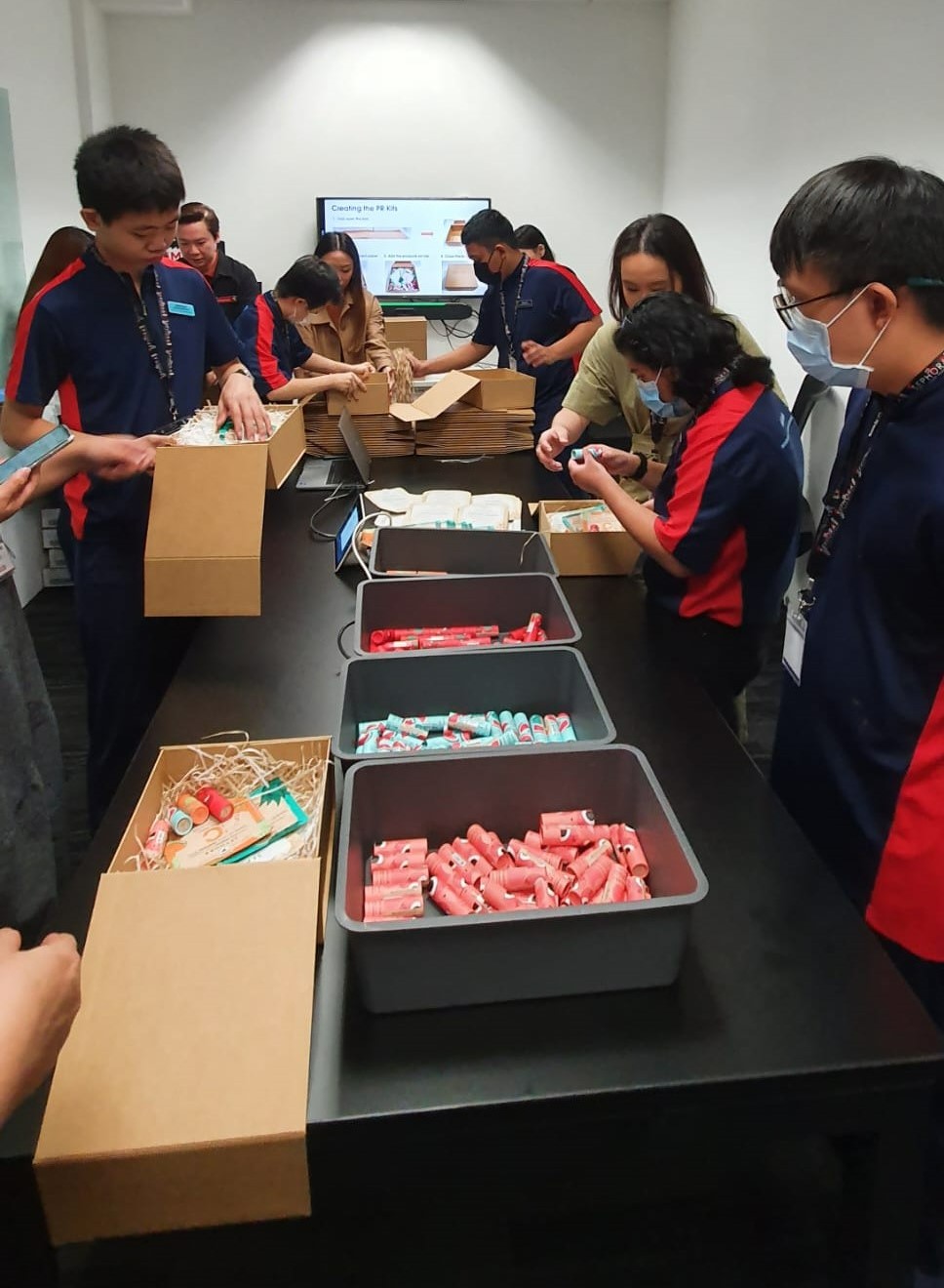 Students helping to pack PR kits, with the guidance of Sephora and school staff