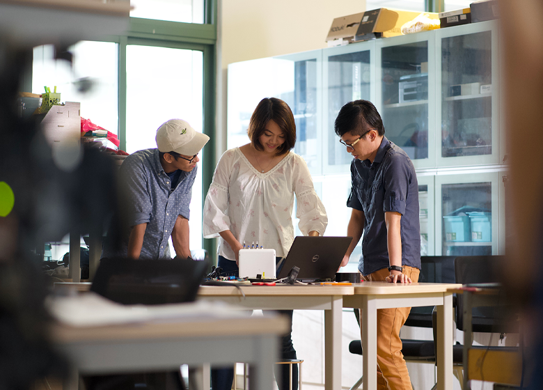 A group of adults working on a project together.