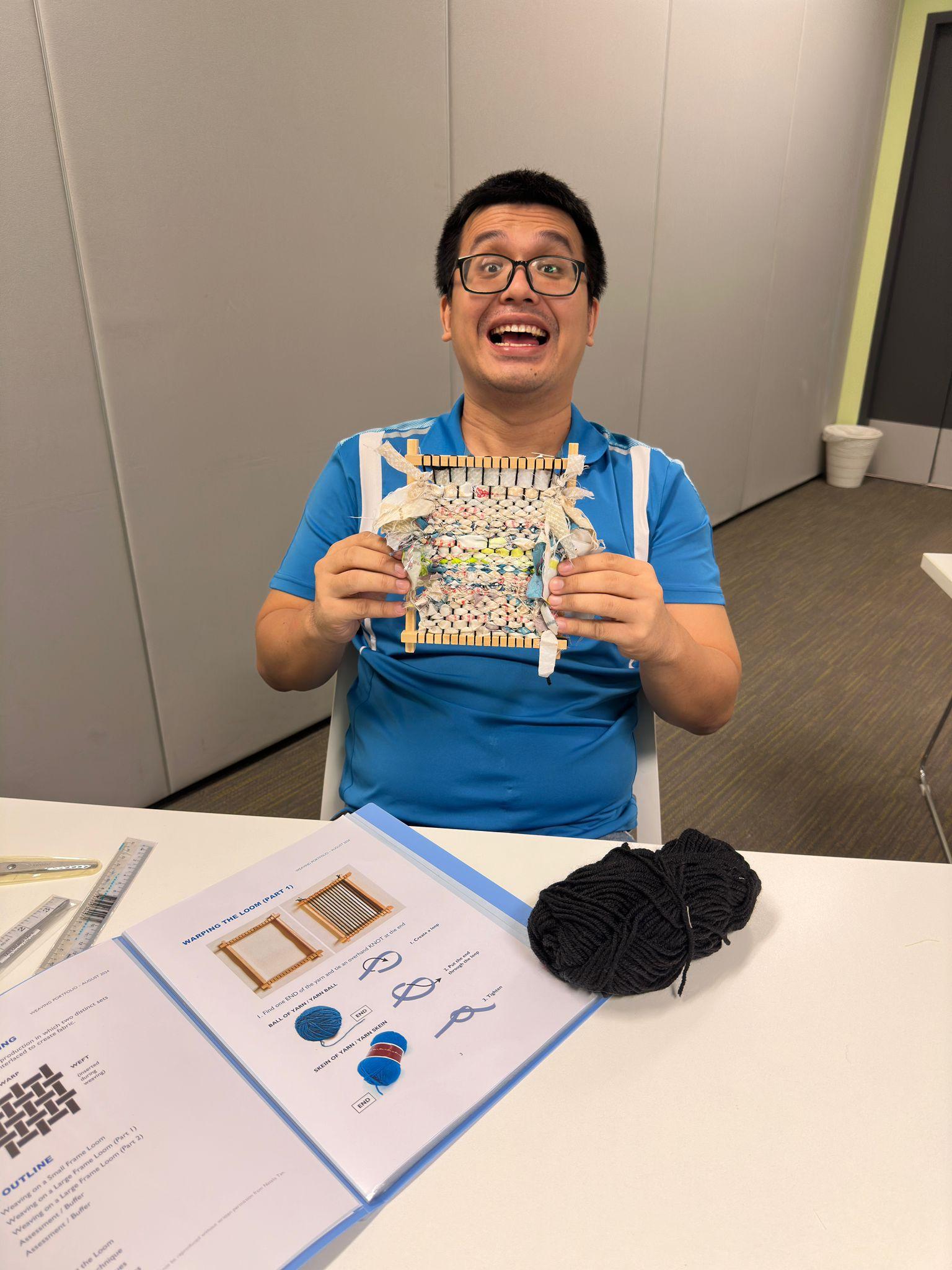 re-store-1 individual holding up artwork and smiling