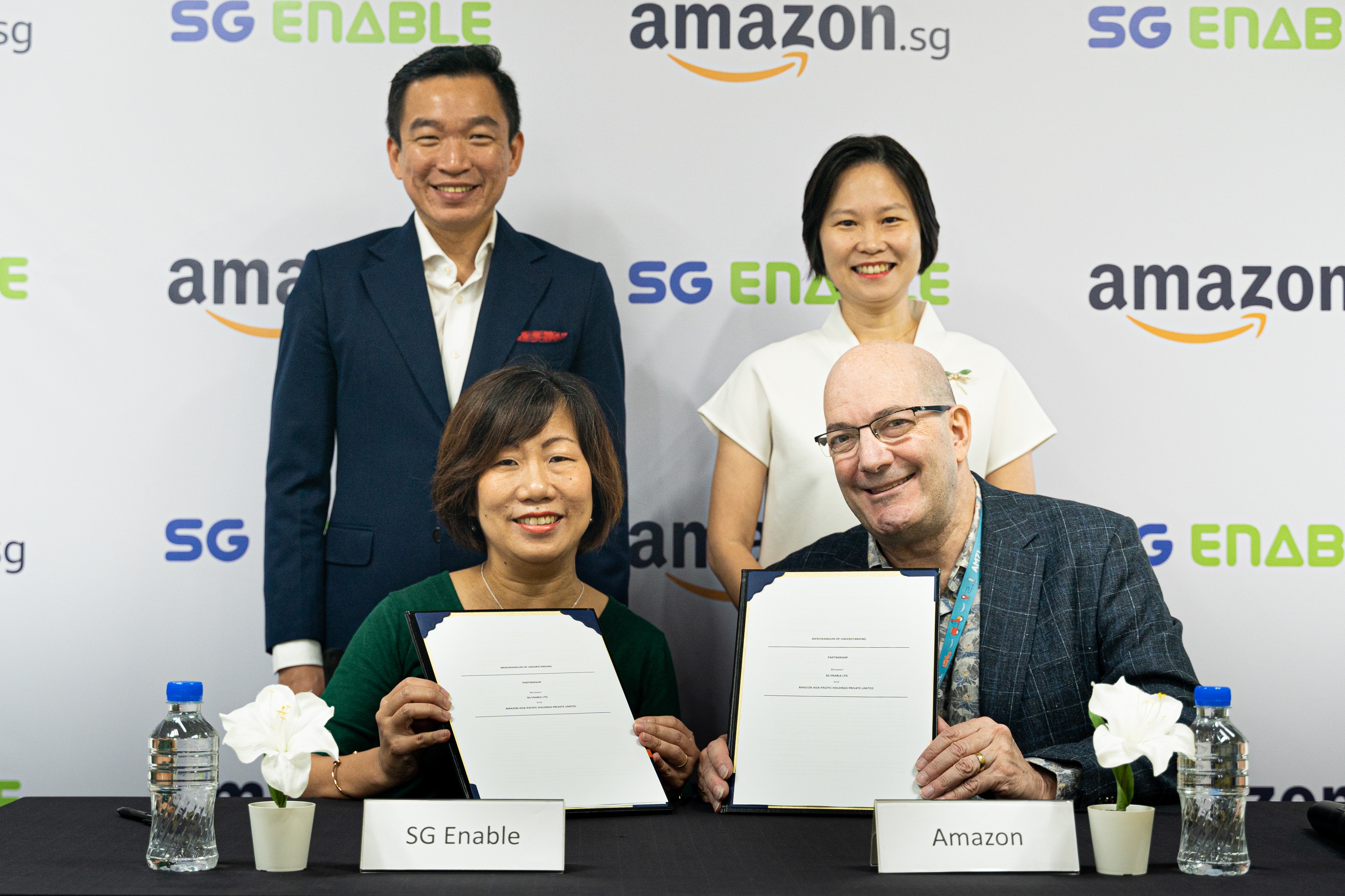 Ms. Ku Geok Boon, Mr. Steve Walter, Mr. Eric Chua and Ms. Gan Siow Huang posing with the signed MOUs