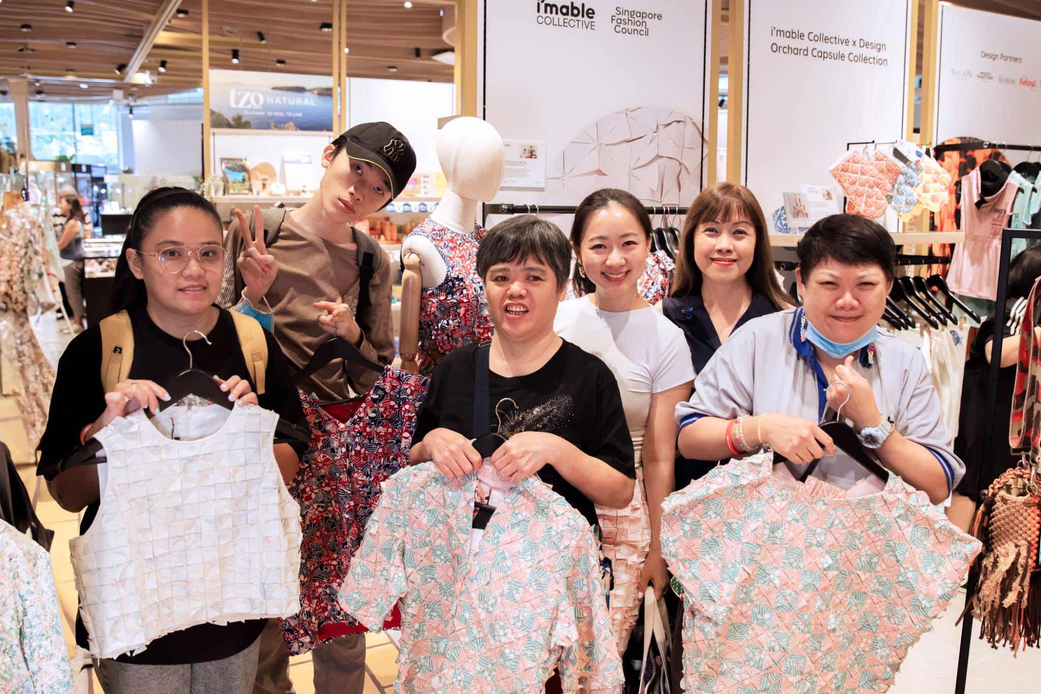 group of individuals holding up products and taking a picture