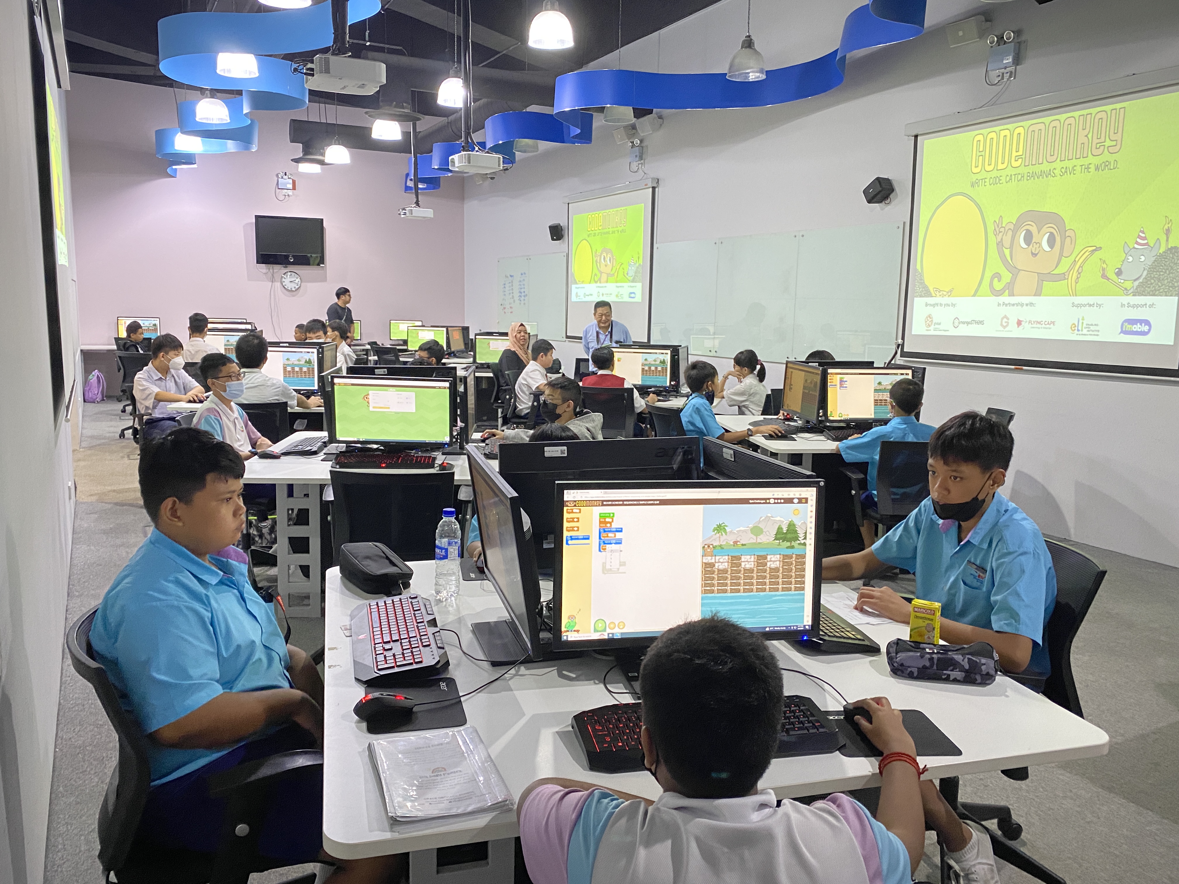 SPED school students in front of computers participating in the SPED Coding Olympics.