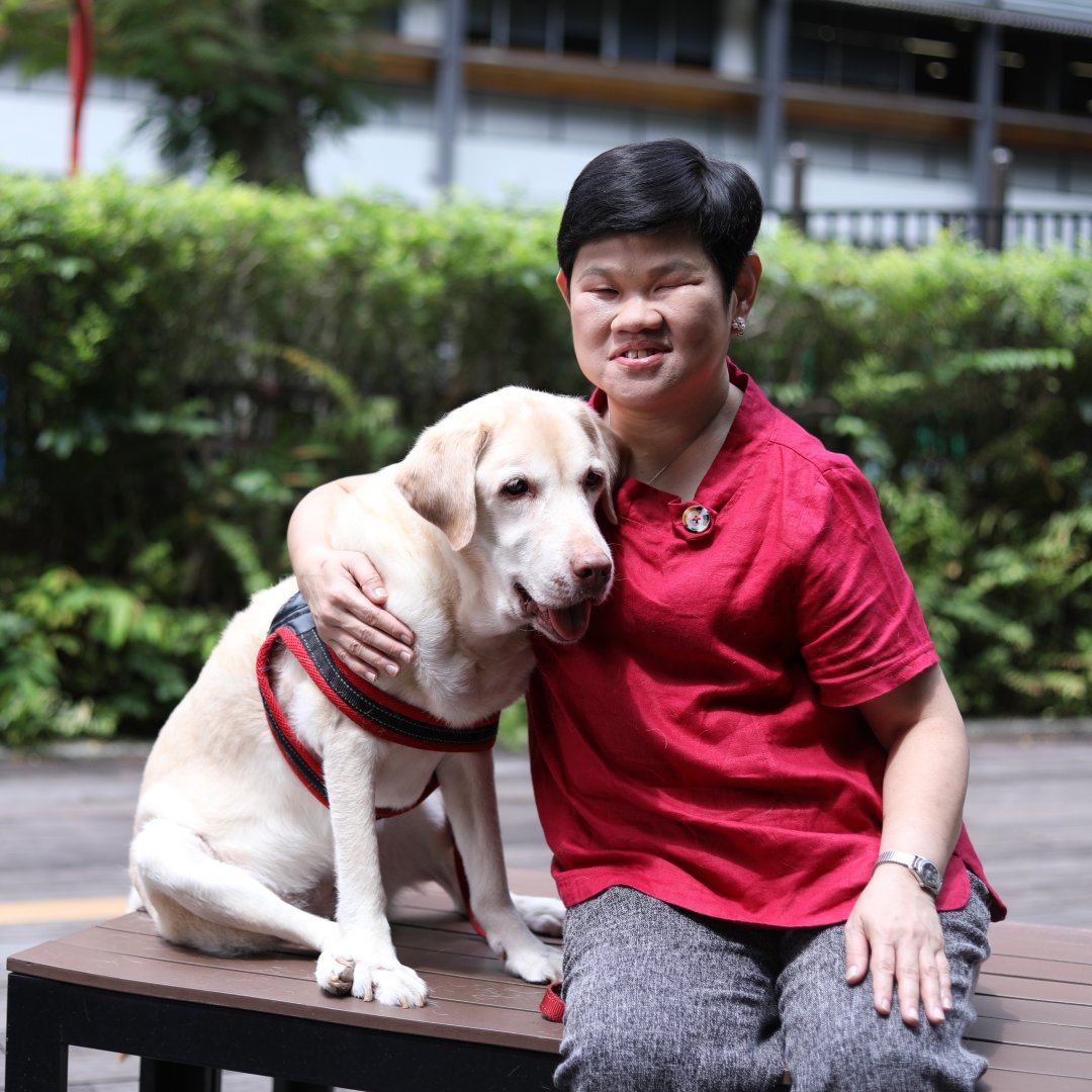 Photo of Lim Lee Lee, Co-Founder of Collective Perspectives with her guide dog