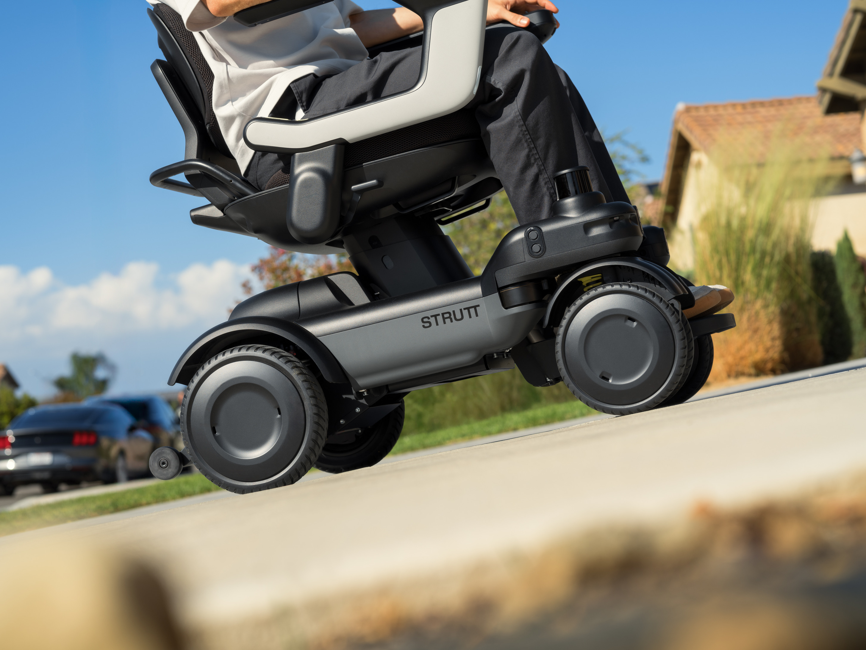 A motorised mobility device going up a slope.